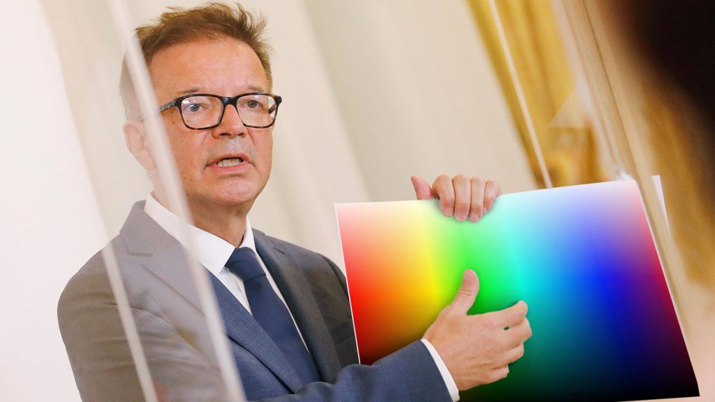 Anschober hält Zettel mit Farbspektrum darauf