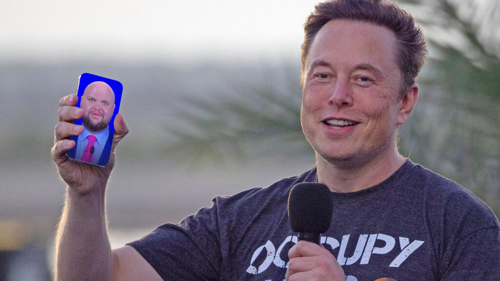 Musk hält Handy hoch, darauf ist ein Vance-Meme zu sehen