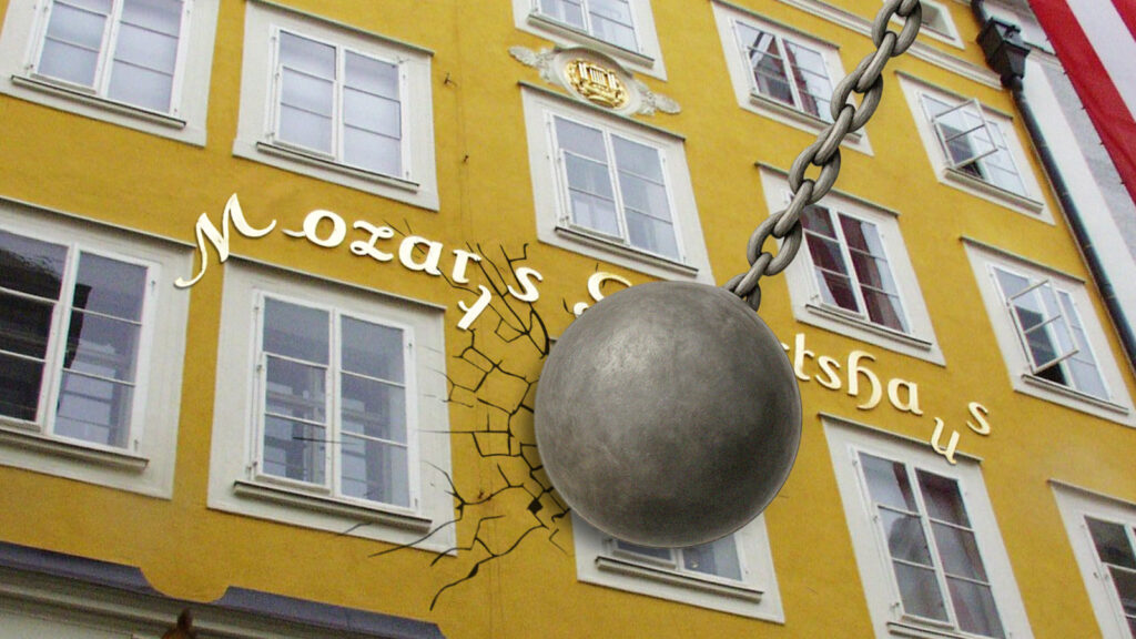 Das Bild zeigt eine Abrissbirne, die die Fassade des Mozartgeburtshauses beschädigt.