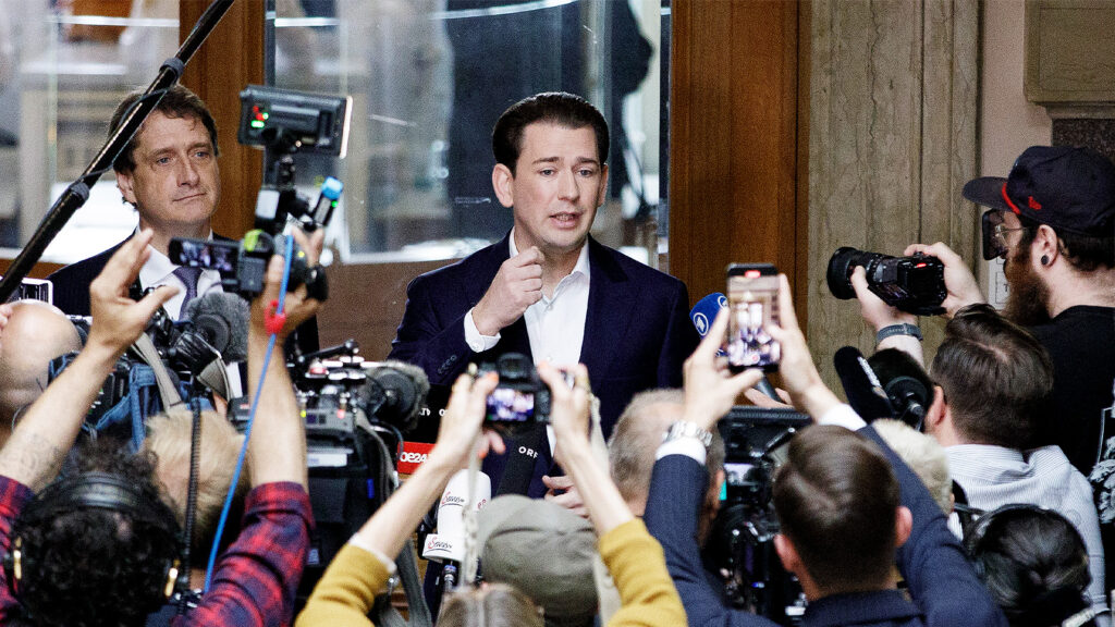 Das Bild zeigt Sebastian Kurz umringt von Kameras, Mikros und Journalisten.
