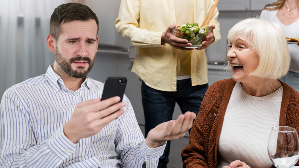 Das Bild zeigt einen genervten Mann, der auf sein Handy schaut. Daneben lacht seine Oma.